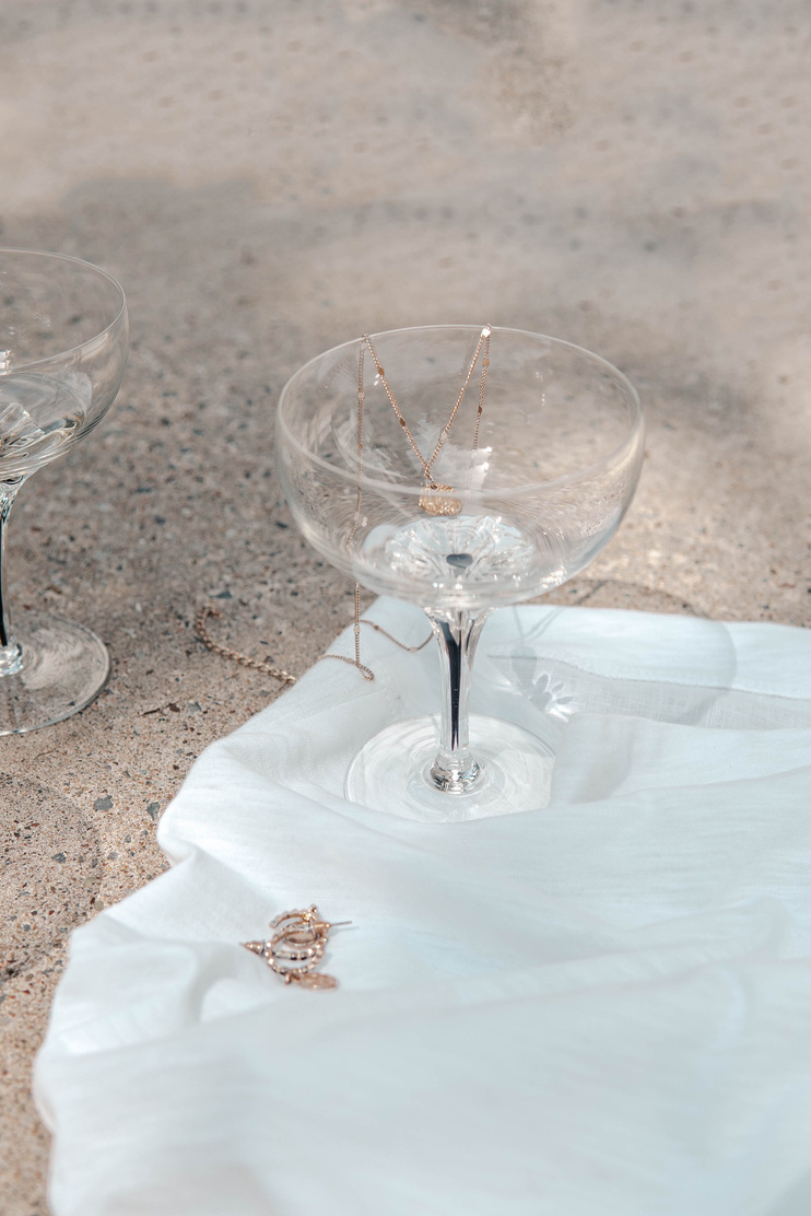 2 Clear Wine Glasses on White Textile